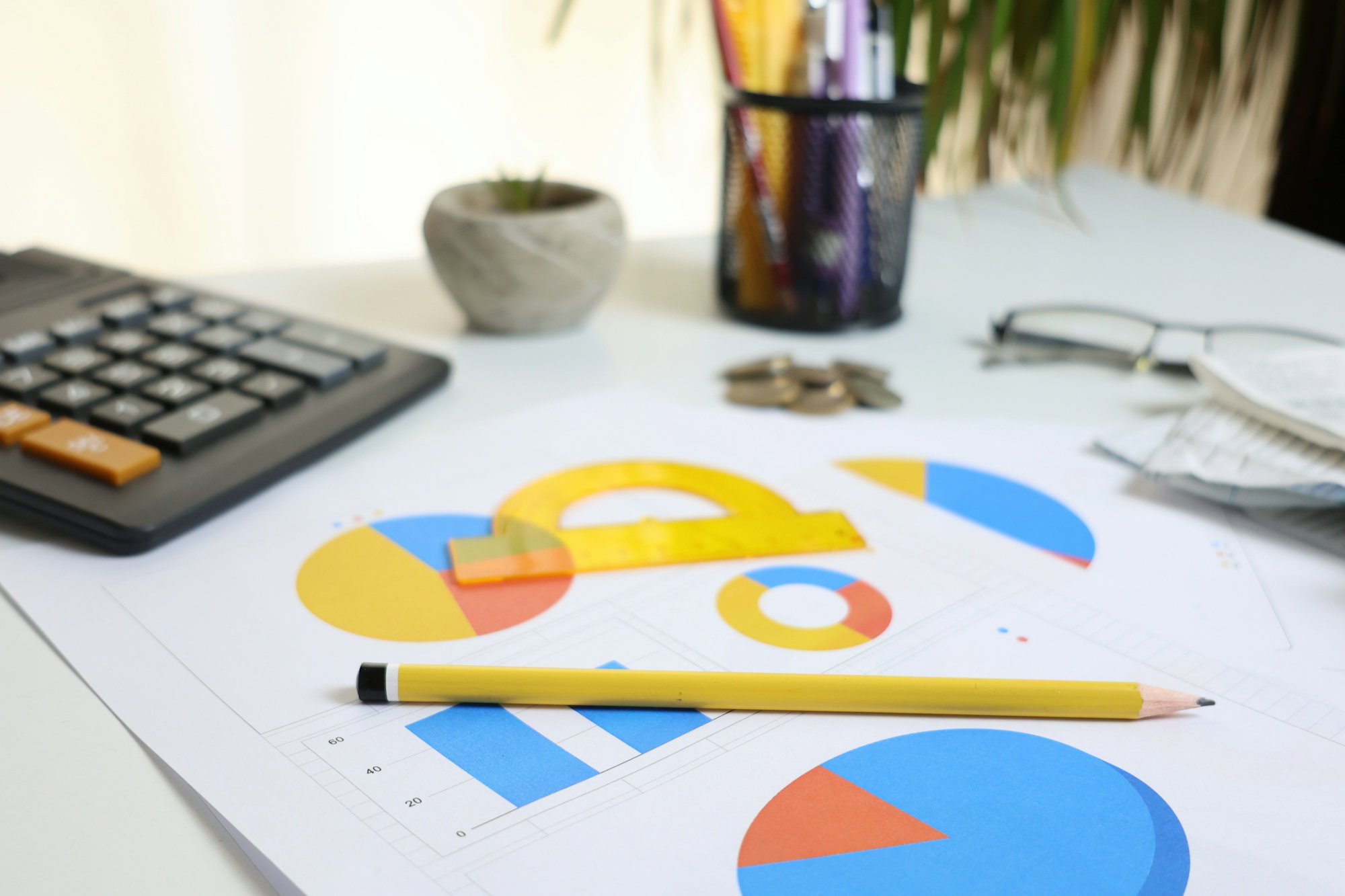 desk-with-calculator--charts--and-pencil.jpg Desk with calculator, charts, and pencil